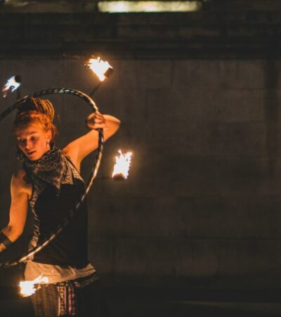 a woman with a fire hoop